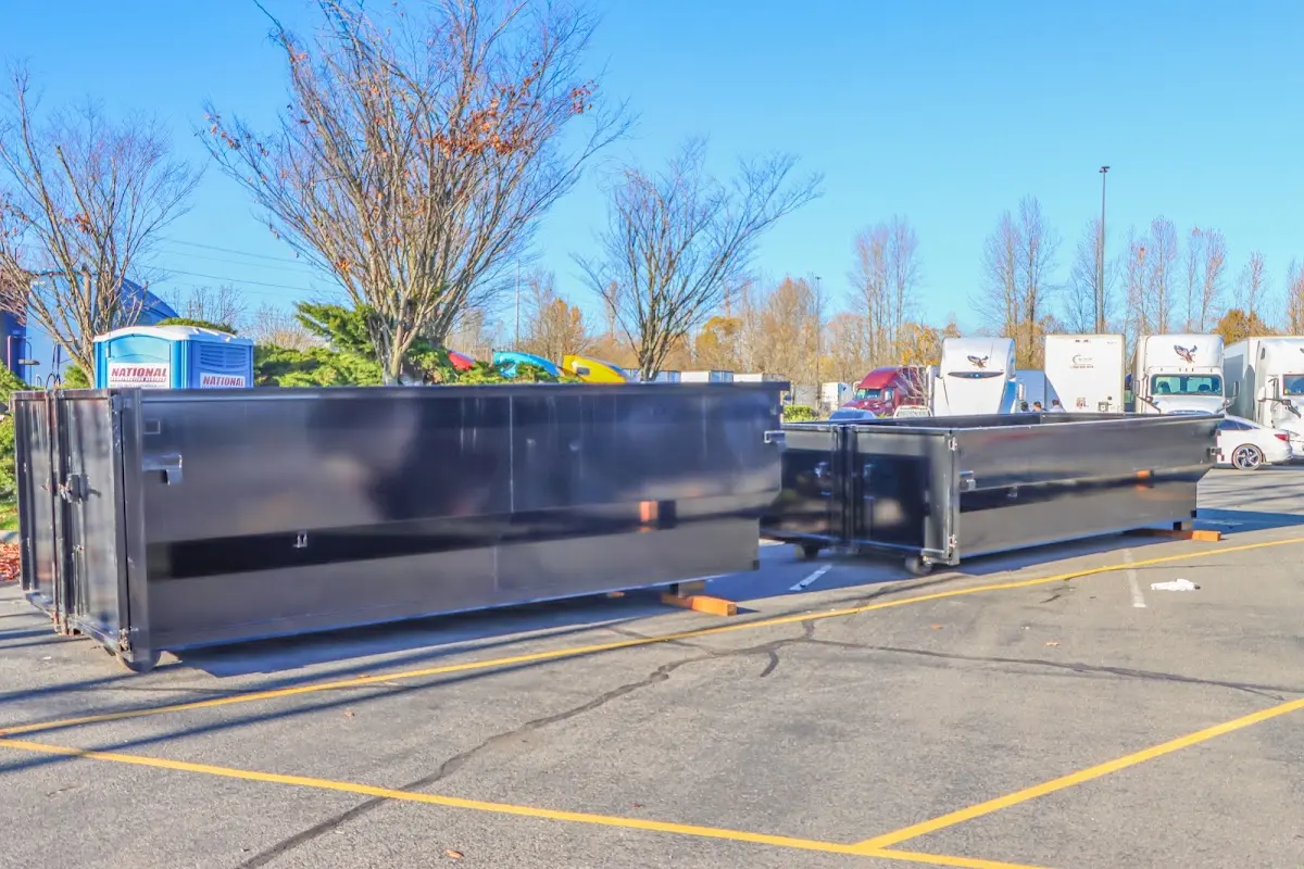 Professional dumpster rental service with roll-off container on residential driveway in Loudoun Valley Estates